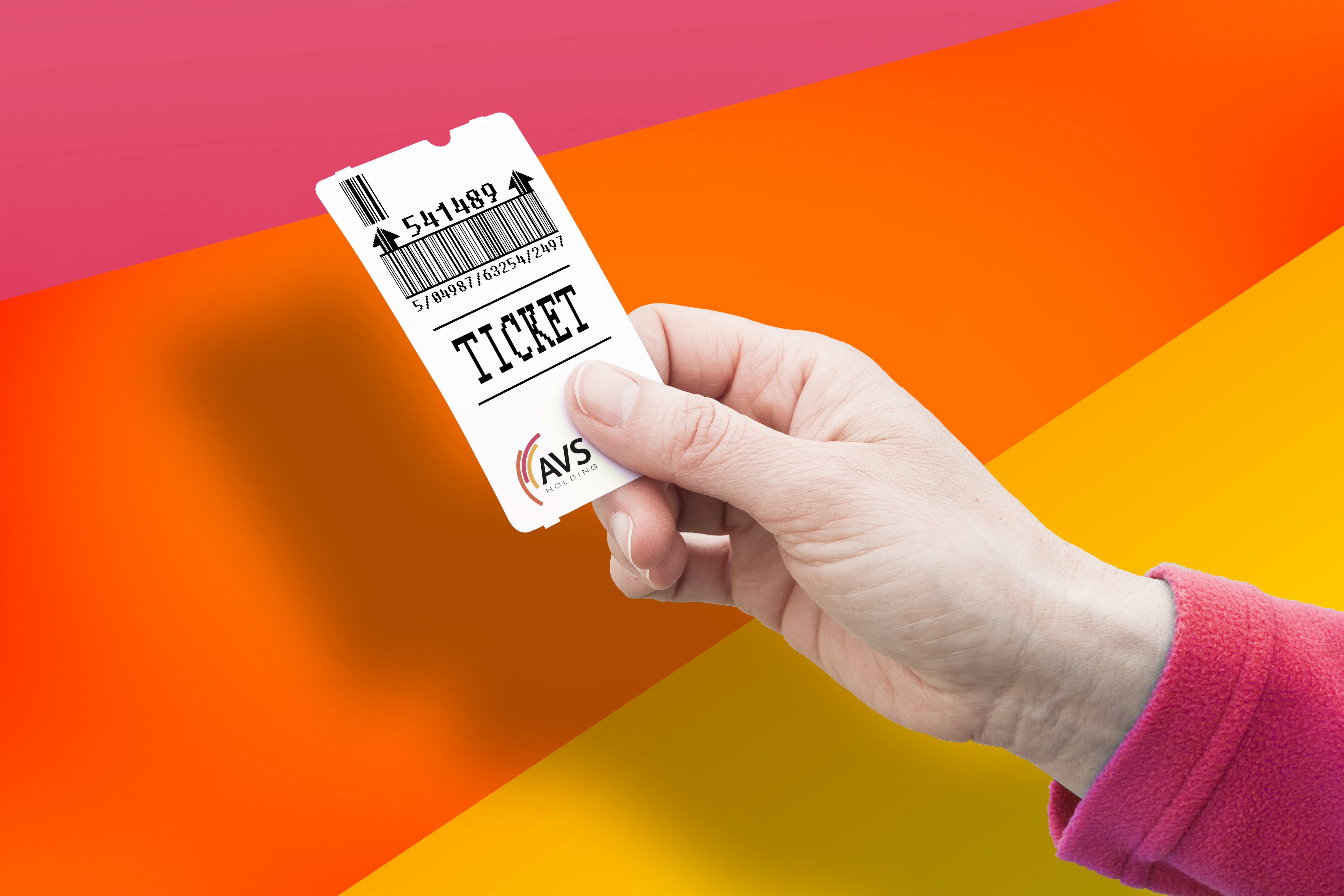 Foto: Eine Hand hält ein Parkticket vor einem bunten Hintergrund.